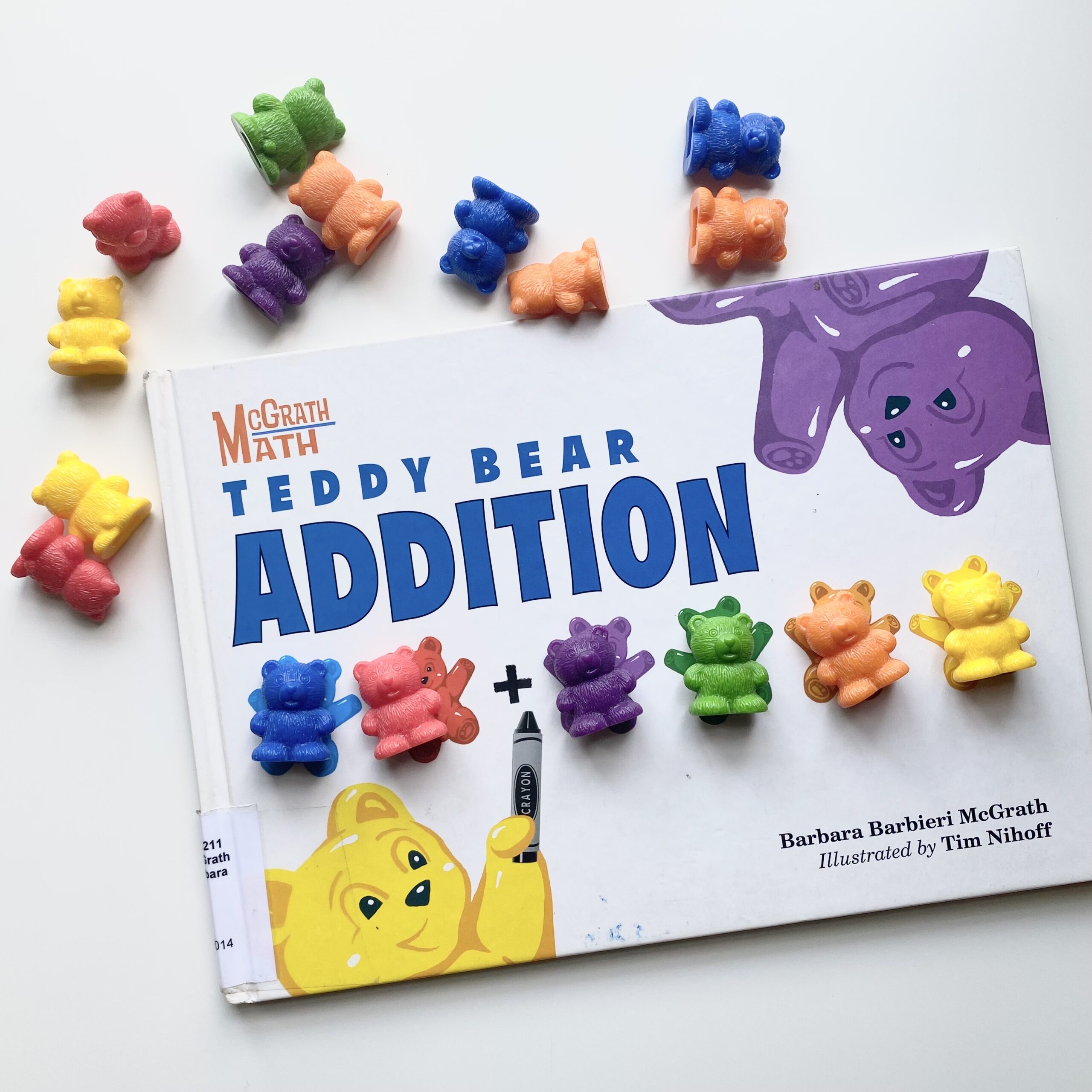 Teddy Bear Addition children's book with brightly colored counting bears surrounding it.